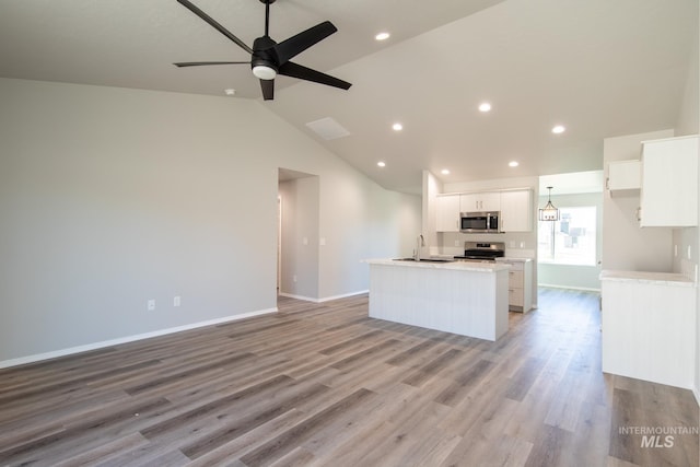 310 Chalcedony Ave, Caldwell, ID 83605 - kitchen with white cabinetry, a kitchen island with sink, stainless steel appliances, and open floor plan