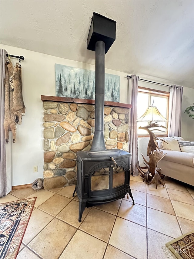 interior details featuring a wood stove and a textured ceiling