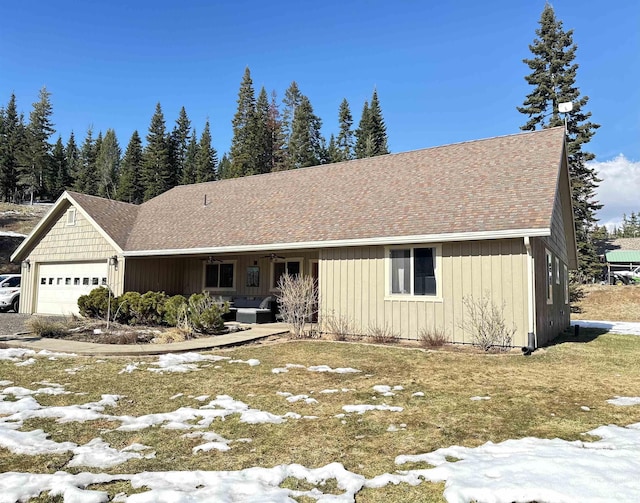 single story home with roof with shingles and an attached garage