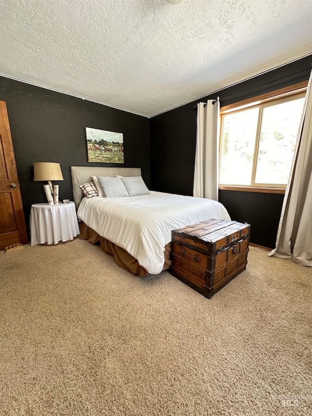 carpeted bedroom featuring a textured ceiling