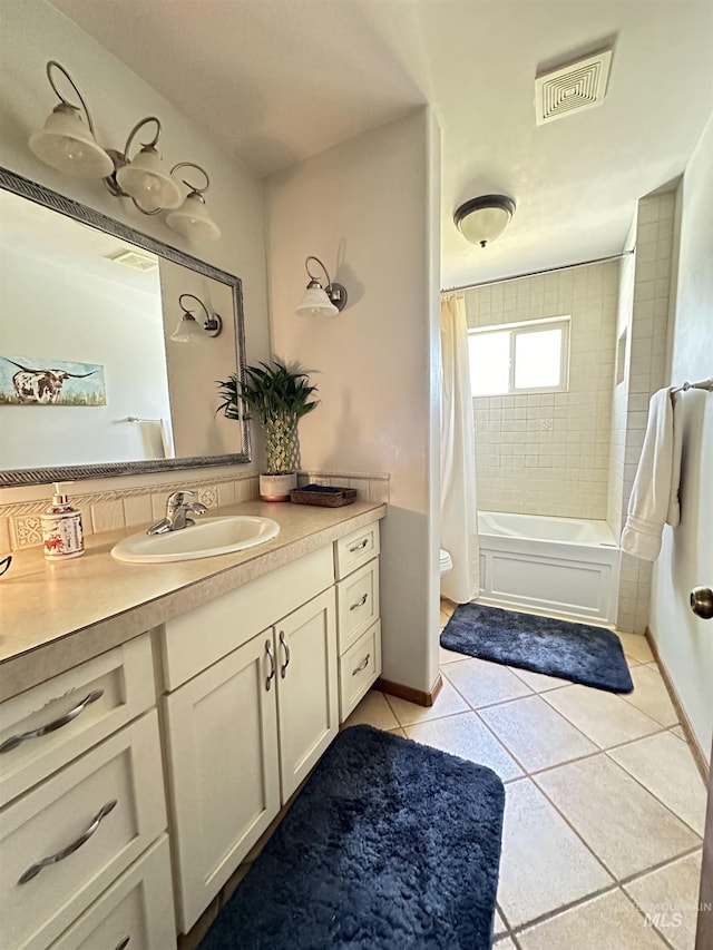 full bathroom with tile patterned flooring, visible vents, toilet, vanity, and shower / bathtub combination with curtain