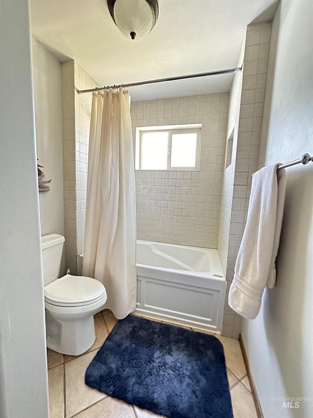 bathroom with tile patterned floors, toilet, shower / bathtub combination with curtain, and baseboards