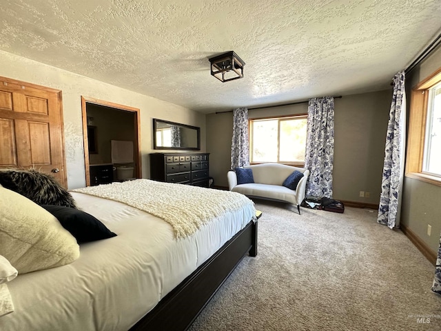 carpeted bedroom with a textured ceiling and baseboards