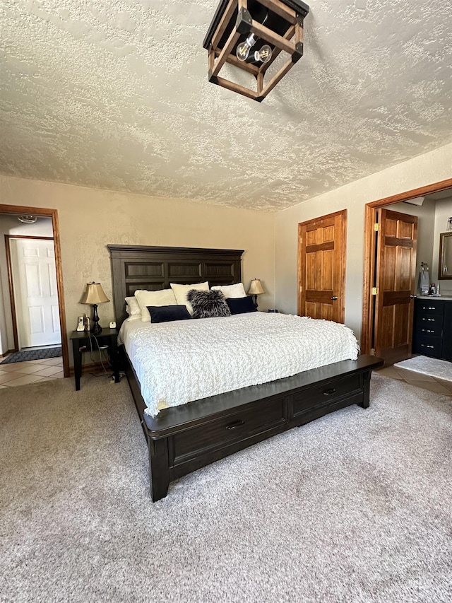 bedroom with carpet floors, a textured ceiling, and a textured wall