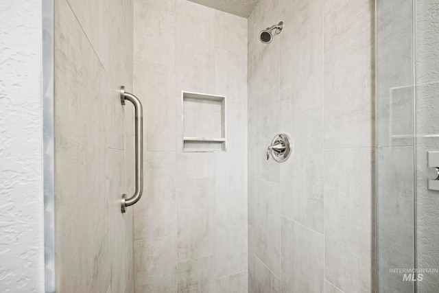 bathroom with a shower with door