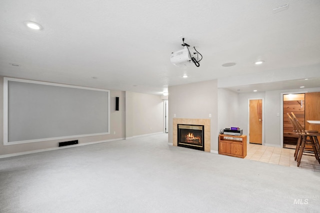 interior space featuring a tiled fireplace, recessed lighting, baseboards, and light carpet