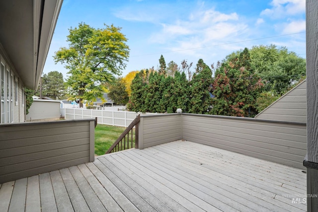 wooden terrace featuring a yard