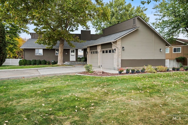 view of front of property with a front lawn and a garage