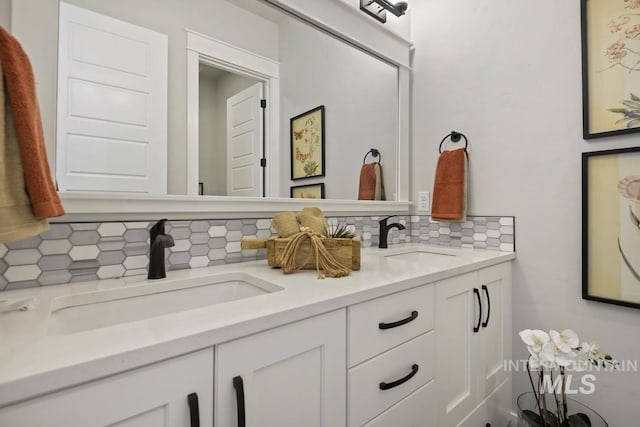 full bath featuring double vanity, decorative backsplash, and a sink