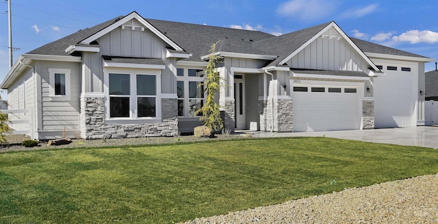 view of front of house with an attached garage, stone siding, board and batten siding, a front yard, and concrete driveway
