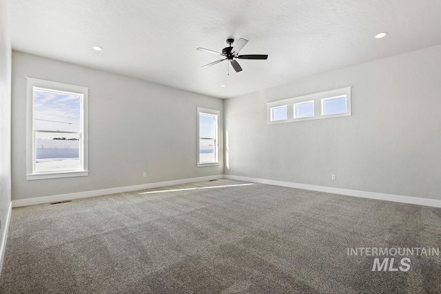 unfurnished room featuring carpet floors, visible vents, baseboards, recessed lighting, and a ceiling fan
