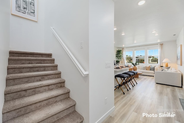 stairway with hardwood / wood-style floors