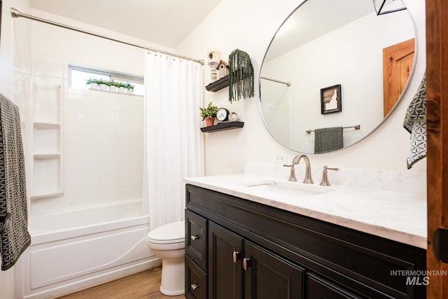 full bath featuring toilet, wood finished floors, vanity, and shower / bath combo with shower curtain