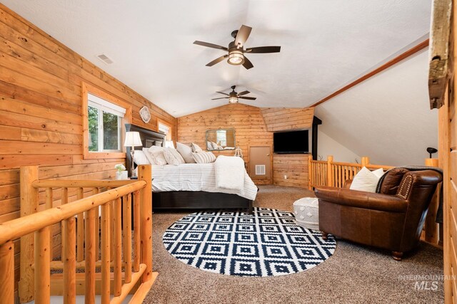 bedroom with carpet flooring, wood walls, vaulted ceiling, and ceiling fan