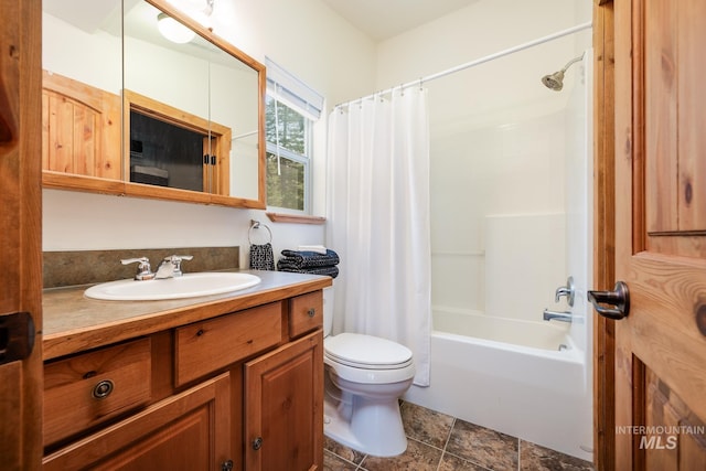 bathroom with toilet, vanity, and shower / bath combo with shower curtain
