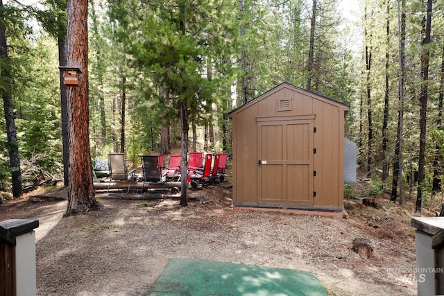 view of shed featuring a wooded view
