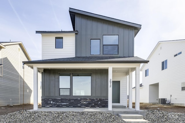 contemporary home featuring board and batten siding, a porch, and central AC