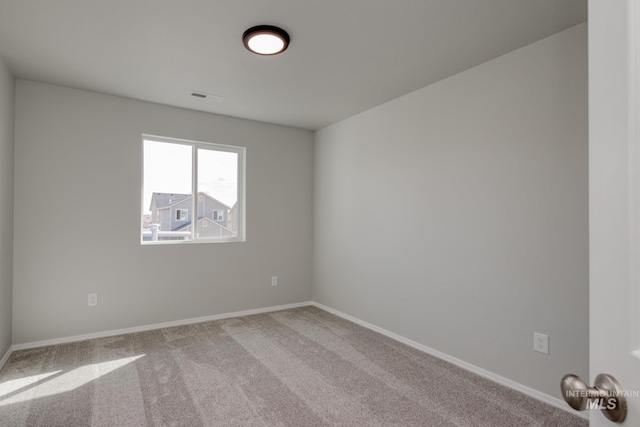unfurnished room featuring carpet, baseboards, and visible vents