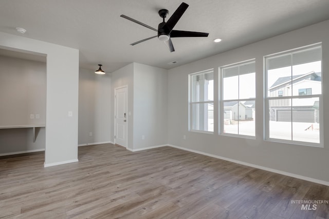 spare room with recessed lighting, baseboards, a ceiling fan, and wood finished floors