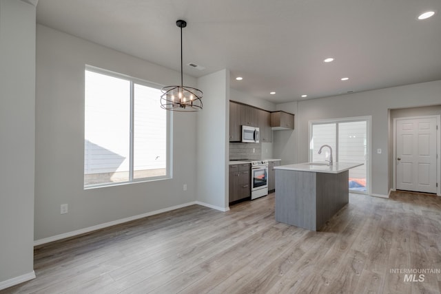 kitchen with light countertops, appliances with stainless steel finishes, and plenty of natural light