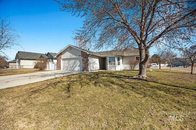 single story home featuring brick siding, fence, a front yard, a garage, and driveway