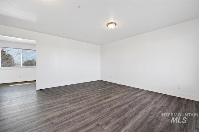 empty room featuring dark hardwood / wood-style flooring