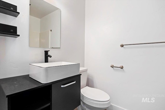 bathroom featuring toilet and vanity