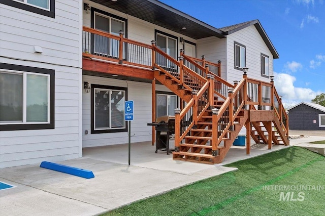 rear view of house featuring a yard and a patio