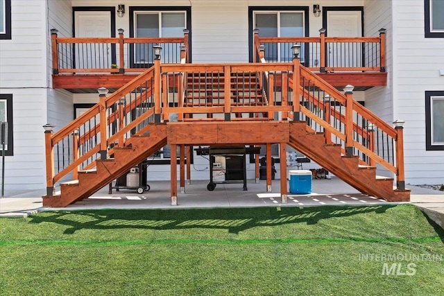 exterior space with a wooden deck, a yard, and a patio area