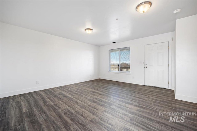 empty room featuring dark hardwood / wood-style flooring