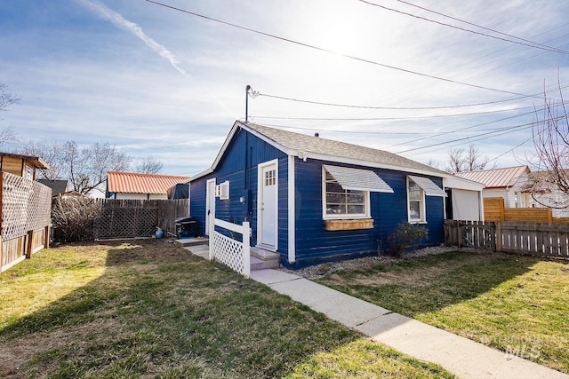 view of front of property with a front yard and a fenced backyard