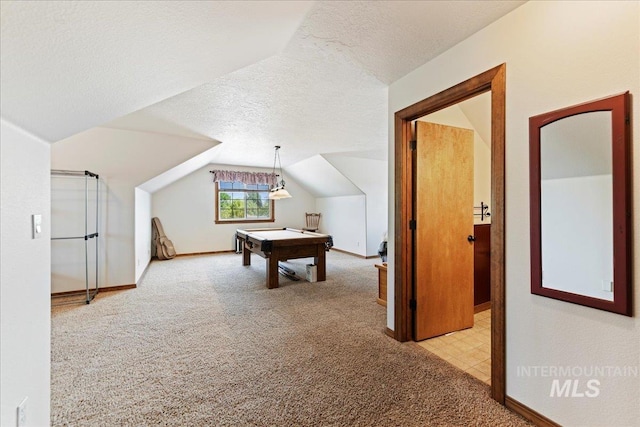 recreation room with light carpet, pool table, vaulted ceiling, and a textured ceiling