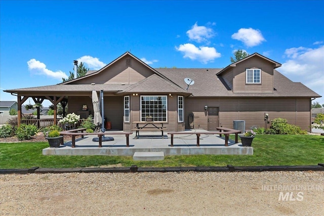 rear view of property with a lawn