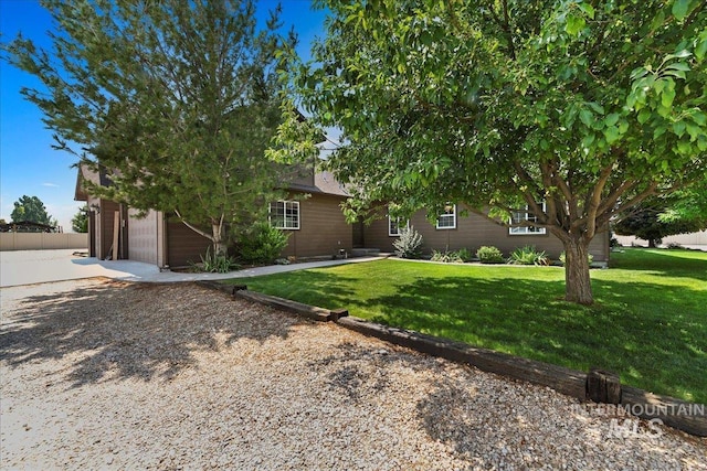 view of property hidden behind natural elements with a front lawn