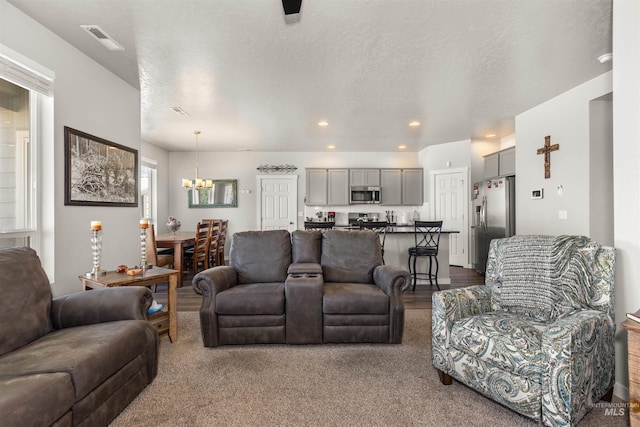 1417 Scranton Ave, Caldwell, ID 83605 - living room featuring a chandelier, dark colored carpet, and recessed lighting