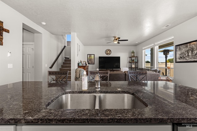 1417 Scranton Ave, Caldwell, ID 83605 - kitchen featuring ceiling fan, open floor plan, dark stone countertops, a textured ceiling, and a sink