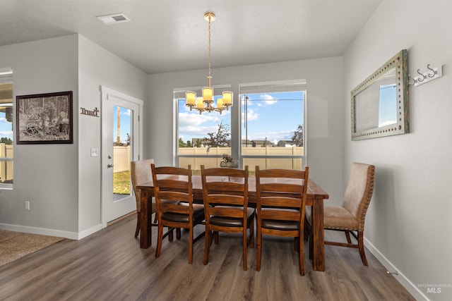 1417 Scranton Ave, Caldwell, ID 83605 - dining room with a chandelier, wood finished floors, and baseboards