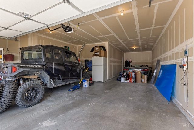 1417 Scranton Ave, Caldwell, ID 83605 - garage featuring freestanding refrigerator and a garage door opener