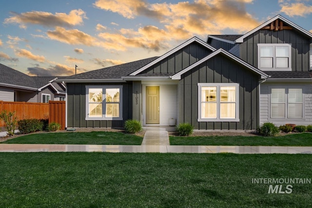 11053 W Clematis St, Boise, ID 83709 - view of front of house featuring board and batten siding, fence, and a lawn