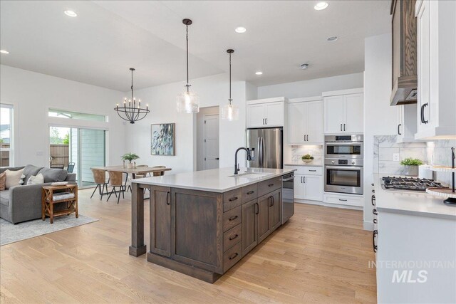 4923 W Canaston St, Meridian, ID 83646 - kitchen featuring a sink, stainless steel appliances, wall chimney exhaust hood, white cabinetry, and recessed lighting