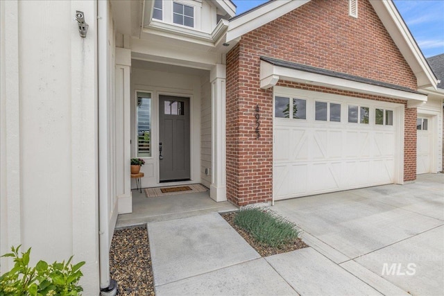 4923 W Canaston St, Meridian, ID 83646 - property entrance featuring brick siding, a garage, and driveway