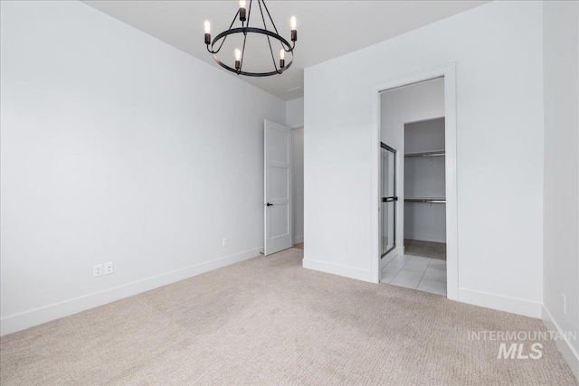 4923 W Canaston St, Meridian, ID 83646 - unfurnished bedroom with a chandelier, carpet floors, baseboards, and a walk in closet