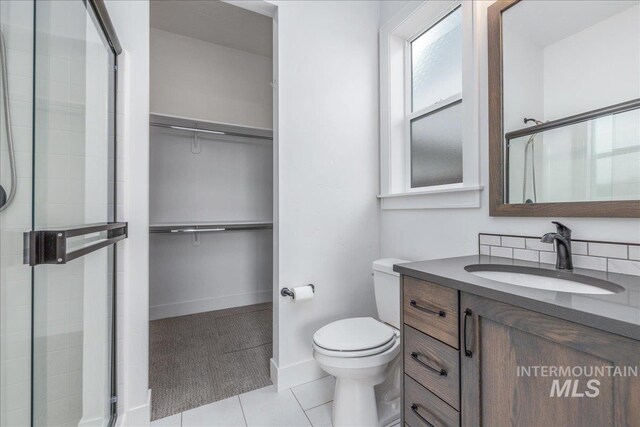 4923 W Canaston St, Meridian, ID 83646 - full bathroom featuring a shower stall, toilet, and a walk in closet