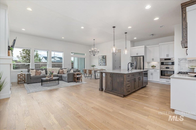 4923 W Canaston St, Meridian, ID 83646 - kitchen featuring appliances with stainless steel finishes, light countertops, white cabinetry, recessed lighting, and a sink