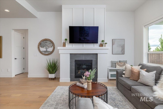 4923 W Canaston St, Meridian, ID 83646 - living area featuring light wood-type flooring, a tiled fireplace, baseboards, and recessed lighting