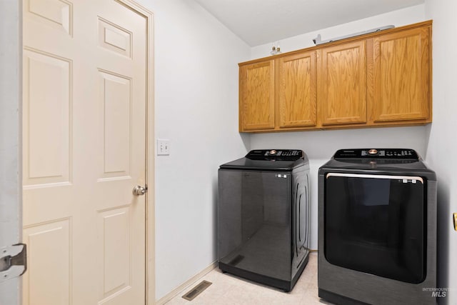 389 Trotter Dr, Twin Falls, ID 83301 - laundry area featuring independent washer and dryer, cabinet space, and baseboards