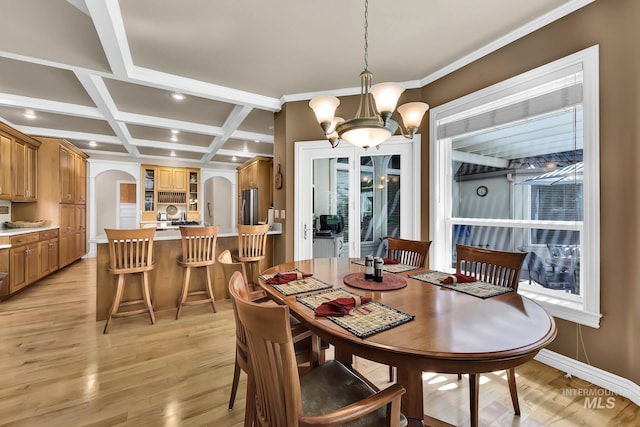 dining space featuring arched walkways, a chandelier, recessed lighting, light wood-type flooring, and coffered ceiling