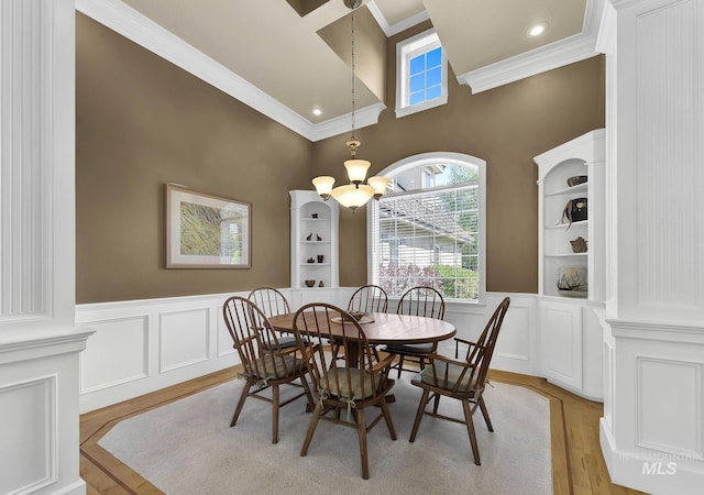 dining room with ornamental molding, wainscoting, and a wealth of natural light