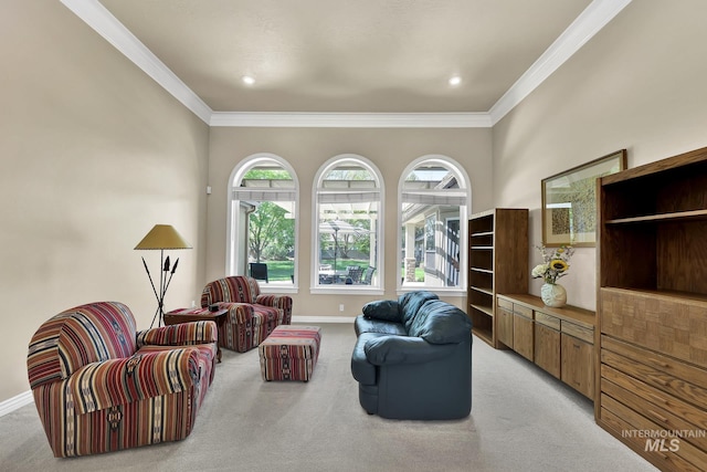 living room featuring light colored carpet, ornamental molding, and baseboards