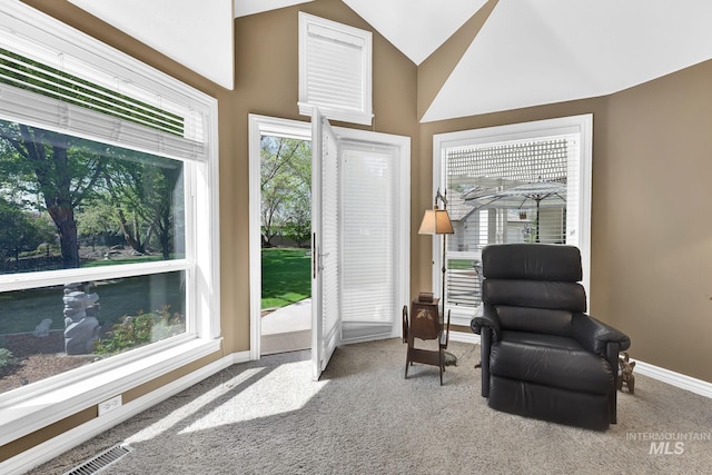 living area featuring visible vents, baseboards, vaulted ceiling, and carpet